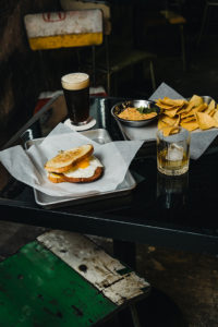 Queso with tortilla chips, beer, whiskey, nuts and sandwich at Bobby's Garage in Nashville TN